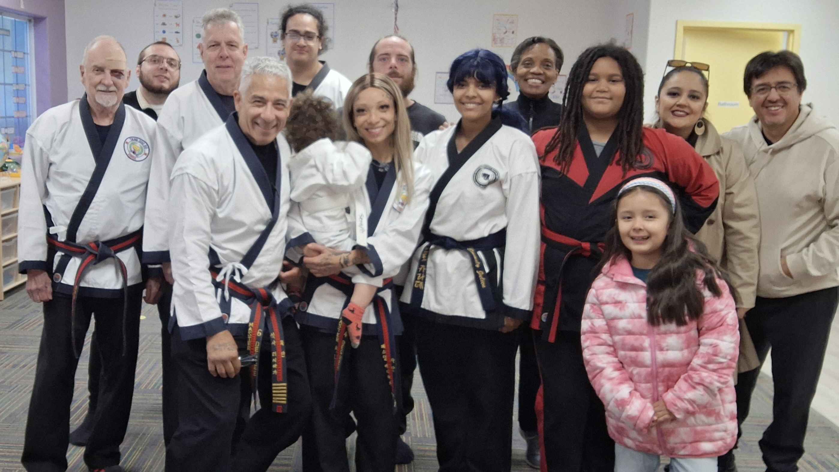 Families, friends, and community supporters together at the first Living Strong Family Martial Arts class