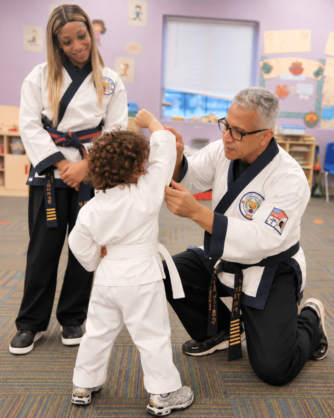 Peter Liciaga teaching his grandson while his daughter Alex watches
